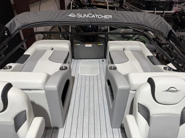 Slide: The Image of 2025 SunCatcher Select 322SS boat interior with gray seating and SunCatcher branding. - 10