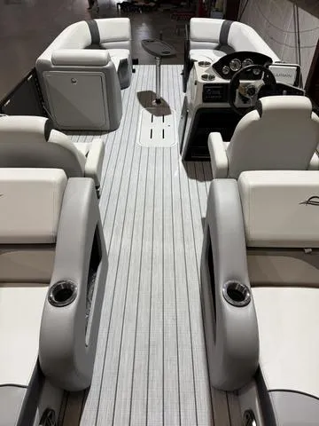 Slide: The Image of 2025 SunCatcher Select 322SS boat interior with luxurious seating and modern dashboard. - 11