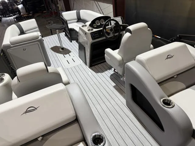 Slide: The Image of 2025 SunCatcher Select 322SS boat interior with luxurious seating and modern dashboard. - 12