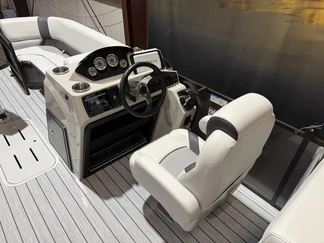 Slide: The Image of 2025 SunCatcher Select 322SS W/VF200XB boat interior with steering console and seating. - 13