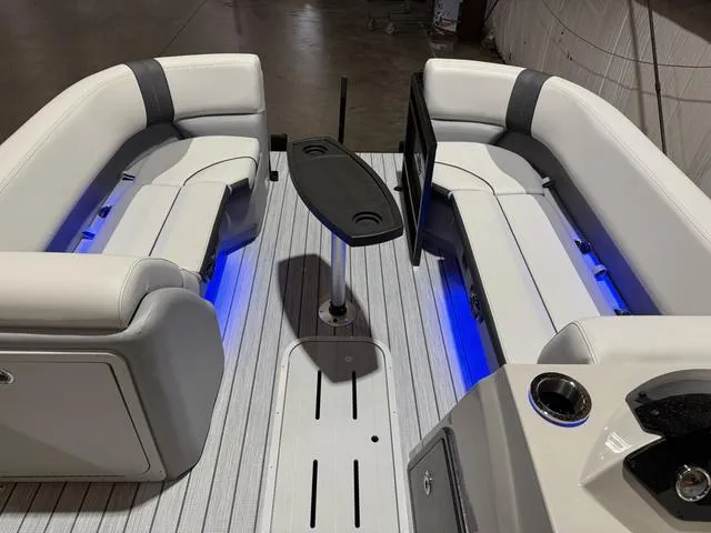 Slide: The Image of 2025 SunCatcher Select 322SS boat interior with LED lighting and seating arrangement. - 15