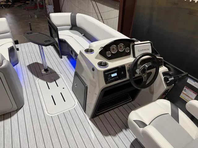 Slide: The Image of 2025 SunCatcher Select 322SS boat interior with modern helm, seating, and Garmin navigation system. - 17