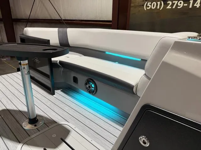 Slide: The Image of 2025 SunCatcher Select 322SS boat interior with LED lighting and seating. - 18