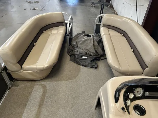 Slide: The Image of 2019 Sun Tracker PARTY BARGE 18 DLX interior with beige seating and dashboard. - 11