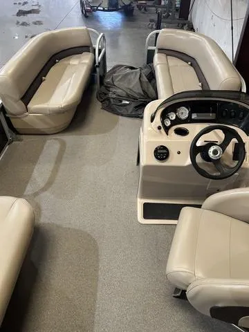 Slide: The Image of 2019 Sun Tracker PARTY BARGE 18 DLX interior with seating and steering console. - 14
