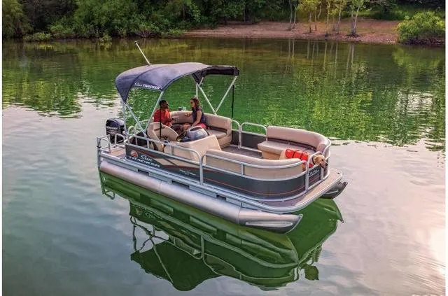 Slide: The Image of 2019 Sun Tracker PARTY BARGE 18 DLX pontoon boat on a serene lake. - 16