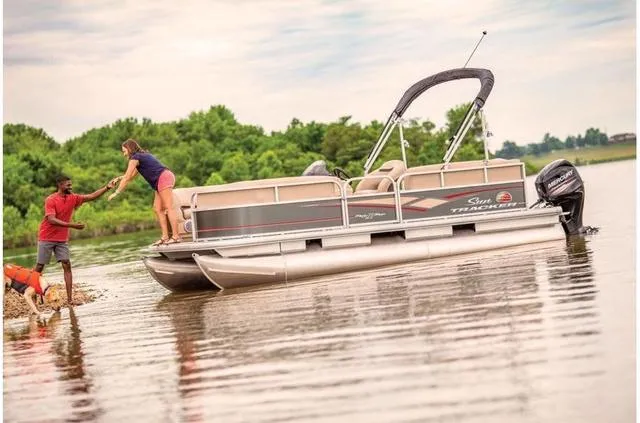Slide: The Image of 2019 Sun Tracker PARTY BARGE 18 DLX on a lake with people boarding. - 17
