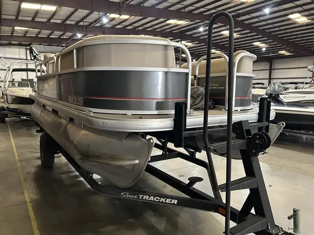 Slide: The Image of 2019 Sun Tracker PARTY BARGE 18 DLX pontoon boat in indoor storage facility. - 3
