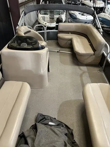 Slide: The Image of 2019 Sun Tracker PARTY BARGE 18 DLX interior with beige seating and Mercury 60 engine. - 6