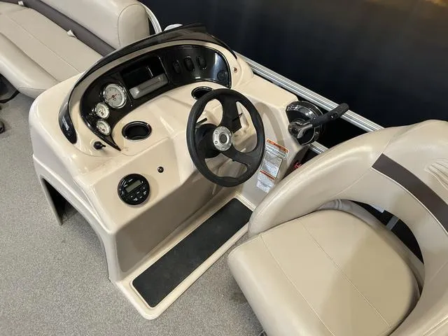 Slide: The Image of 2019 Sun Tracker PARTY BARGE 18 DLX boat console with steering wheel and gauges. - 9