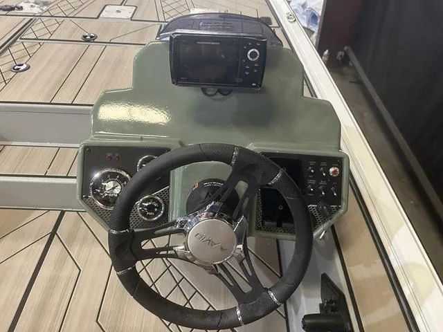 Slide: The Image of 2025 Avid Vertex 18 boat dashboard with steering wheel and control panel. - 14