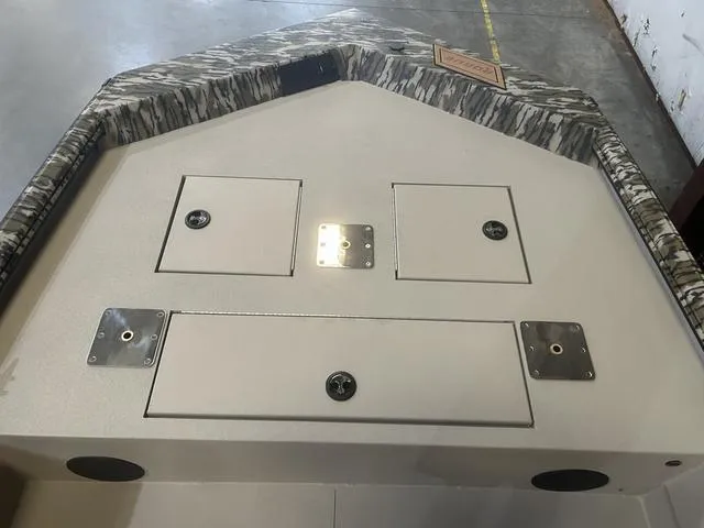 Slide: The Image of 2025 Avid Rogue 20 CC boat deck with storage compartments and camo trim. - 14