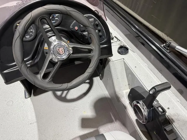 Slide: The Image of 2020 Alumacraft 175 Prowler boat dashboard with steering wheel and controls. - 12