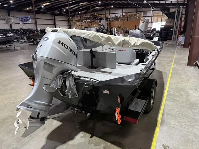 Slide: The Image of 2020 Alumacraft 175 Prowler boat with Honda 50 engine in a warehouse setting. - 4