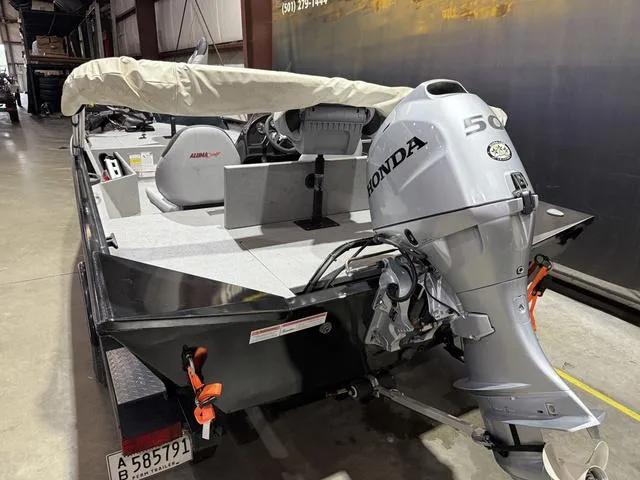 Slide: The Image of 2020 Alumacraft 175 Prowler boat with Honda 50 engine in a warehouse setting. - 5