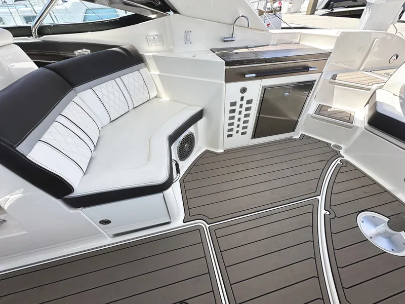Slide: The Image of 2017 Sea Ray SLX 350 interior with sleek seating and modern amenities. - 10