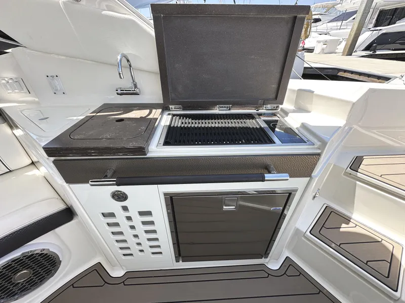 Slide: The Image of Outdoor kitchen on 2017 Sea Ray SLX 350 boat with grill and sink. - 11