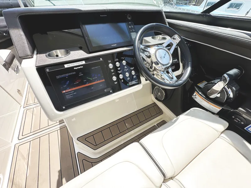 Slide: The Image of 2017 Sea Ray SLX 350 helm with modern controls and luxurious seating. - 21