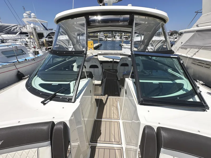 Slide: The Image of 2017 Sea Ray SLX 350 boat interior with open deck and seating at marina. - 28