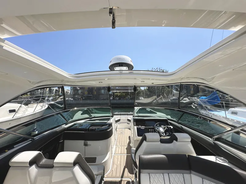 Slide: The Image of 2017 Sea Ray SLX 350 boat interior with open roof and luxurious seating. - 29