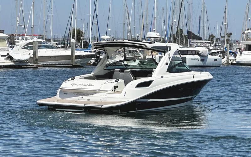 Slide: The Image of 2017 Sea Ray SLX 350 boat docked in a marina with sailboats in the background. - 3