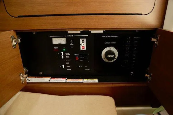 Slide: The Image of Electrical control panel inside 2017 Sea Ray SLX 350 boat, featuring switches and gauges. - 33