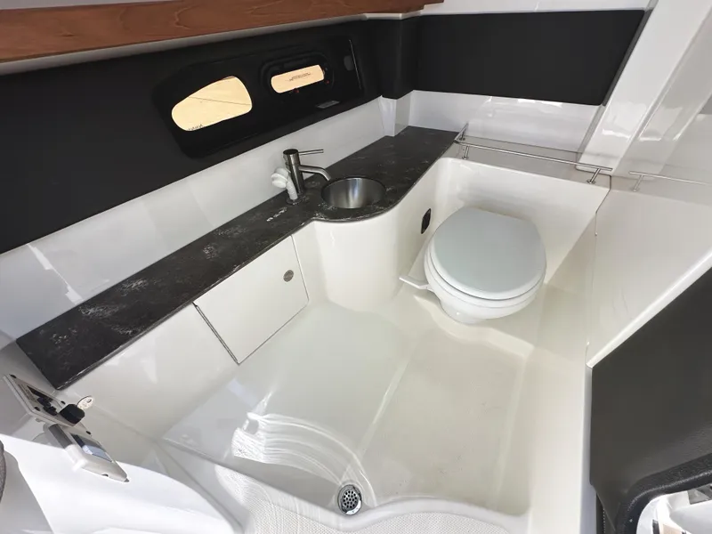 Slide: The Image of 2017 Sea Ray SLX 350 boat bathroom with sink, toilet, and modern design. - 35