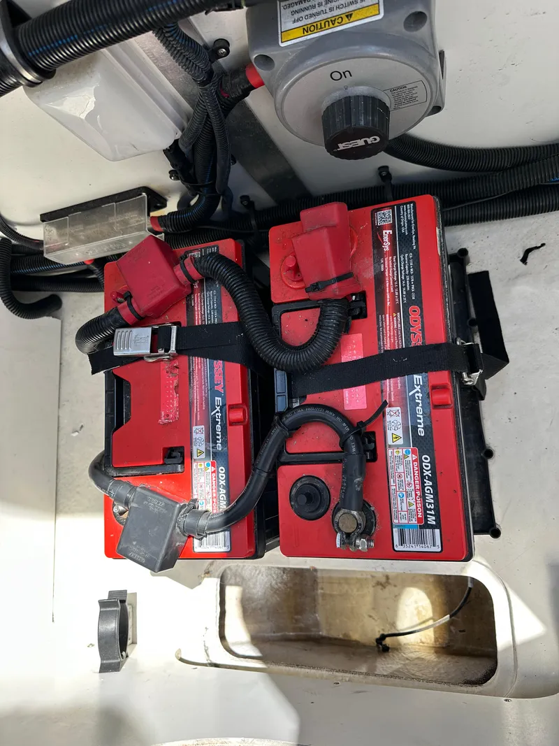 Slide: The Image of 2017 Sea Ray SLX 350 boat batteries with red casings and secured wiring. - 41