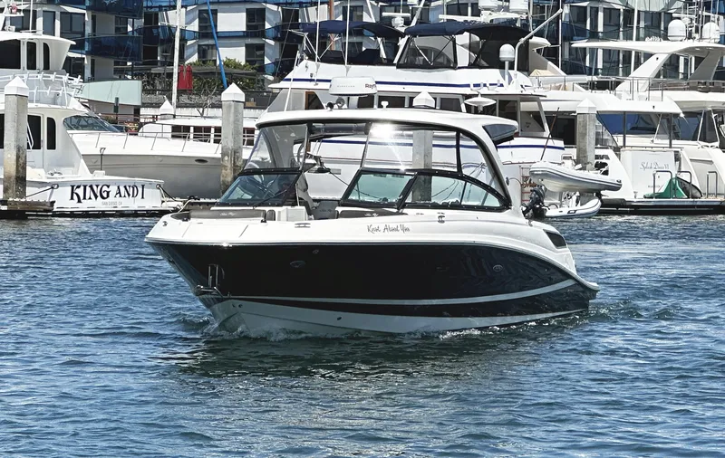 Slide: The Image of 2017 Sea Ray SLX 350 boat cruising in a marina with yachts in the background. - 5