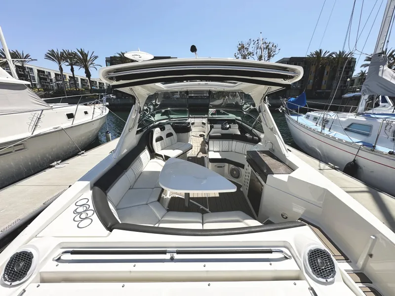 Slide: The Image of 2017 Sea Ray SLX 350 boat interior with seating and table, docked at marina. - 8