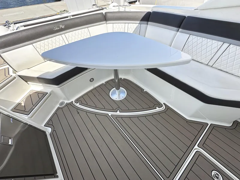 Slide: The Image of Luxurious seating area on 2017 Sea Ray SLX 350 boat with elegant table and flooring. - 9