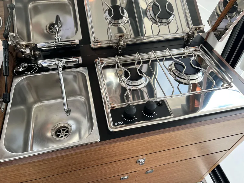 Slide: The Image of Compact kitchen area in 2023 Jeanneau NC 895 boat with stove and sink. - 10
