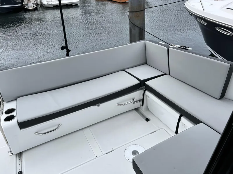 Slide: The Image of 2023 Jeanneau NC 895 boat seating area with gray cushions, docked at marina. - 4
