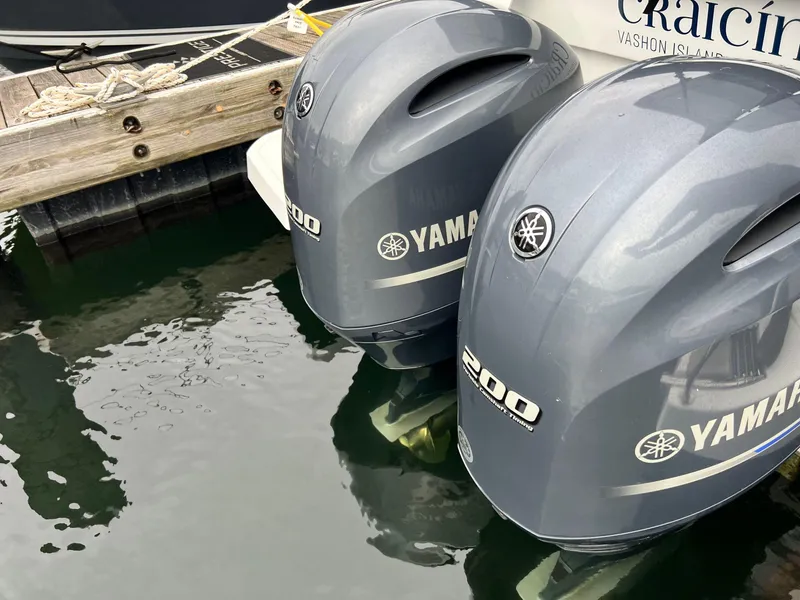Slide: The Image of Twin Yamaha 200 outboard motors on a 2023 Jeanneau NC 895 boat at a dock. - 5