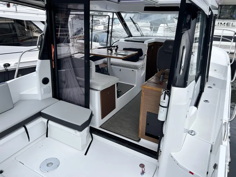 Slide: The Image of 2023 Jeanneau NC 895 boat interior with seating and navigation area. - 6
