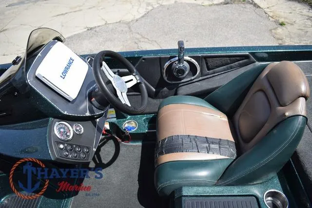 Slide: The Image of 2014 Ranger Z119c boat cockpit with steering wheel, control panel, and cushioned seat. - 10