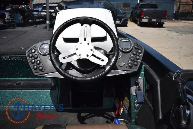 Slide: The Image of 2014 Ranger Z119c boat dashboard with steering wheel and control panel. - 12