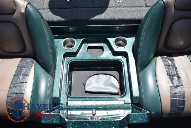 Slide: The Image of 2014 Ranger Z119c boat interior with cup holders and storage compartment. - 18
