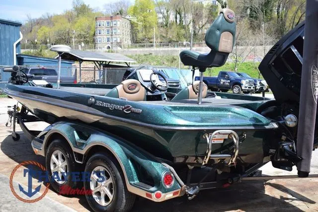 Slide: The Image of 2014 Ranger Z119c fishing boat with trailer, parked outdoors on a sunny day. - 5