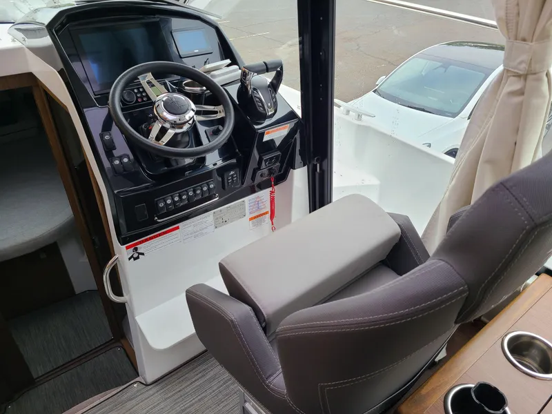 Slide: The Image of 2023 Jeanneau NC 895 helm with modern controls and comfortable seating. - 4
