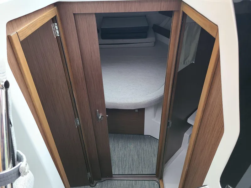 Slide: The Image of 2023 Jeanneau NC 895 cabin interior with wooden door and cozy sleeping area. - 5