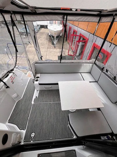 Slide: The Image of 2023 Jeanneau NC 895 boat interior with seating and table, featuring modern design. - 9