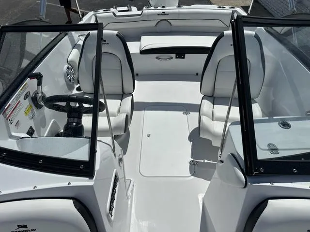 Slide: The Image of 2025 Stingray DC 191 boat interior with white seating and steering wheel. - 10