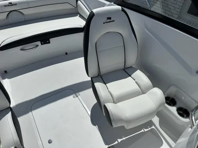 Slide: The Image of 2025 Stingray DC 191 boat interior with white seating and cup holders. - 11