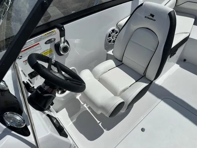 Slide: The Image of 2025 Stingray DC 191 boat interior with white captain's seat and steering wheel. - 12