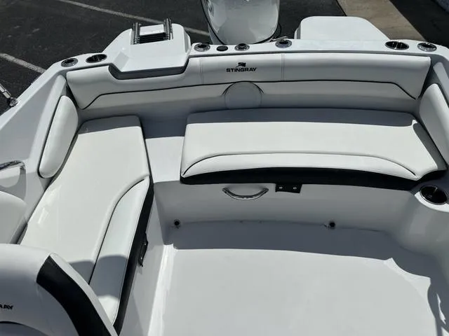 Slide: The Image of 2025 Stingray DC 191 boat interior with white cushioned seating and cup holders. - 13