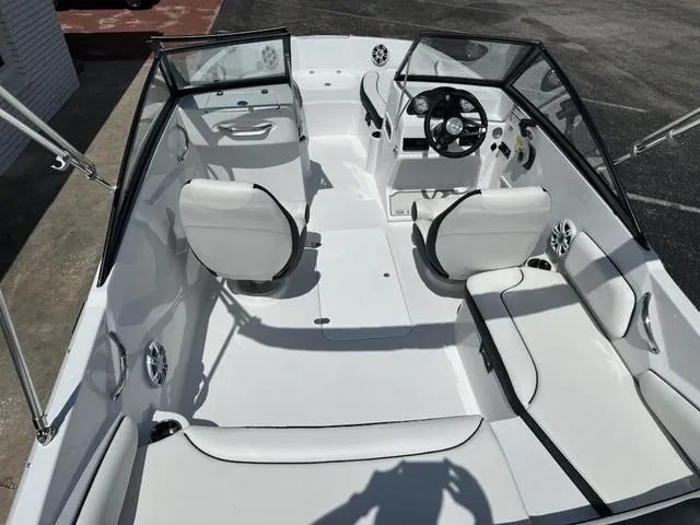 Slide: The Image of 2025 Stingray DC 191 boat interior with white seating and steering console. - 8