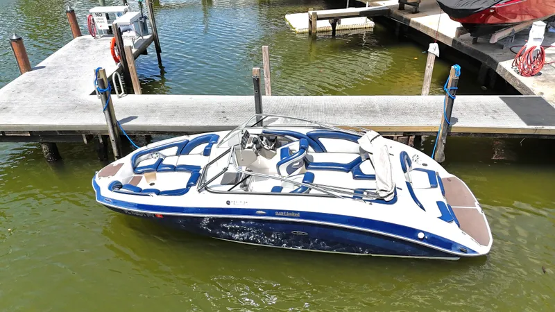 The Image of 2011 Yamaha Boats 242 Limited docked in marina, blue and white design. - 0
