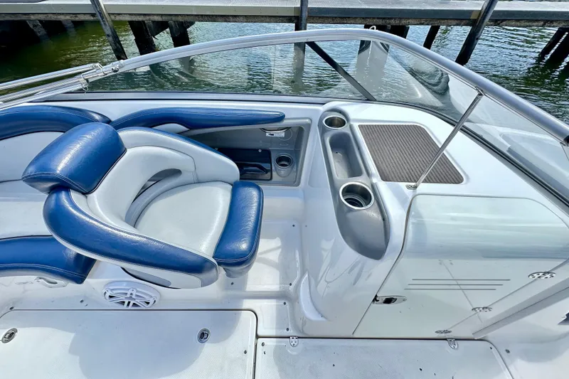 Slide: The Image of 2011 Yamaha Boats 242 Limited interior with blue and white seating, cup holders, and dashboard. - 11