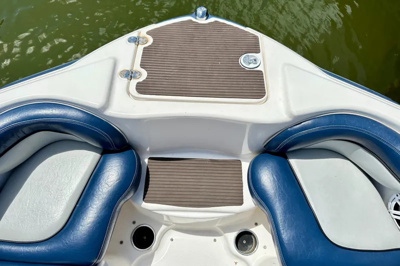 Slide: The Image of 2011 Yamaha Boats 242 Limited bow seating with blue cushions and wood accents. - 15